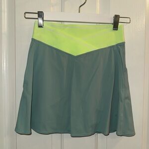 Lululemon athletic tennis skirt in a sage green with neon waistband